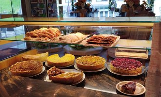 Eine Auswahl an köstlichen Kuchen und Gebäck in einer Auslage. Die Leckereien tönen in verschiedenen Farben und Formen. | © Kleinwalsertal Tourismus | N. Lughammer
